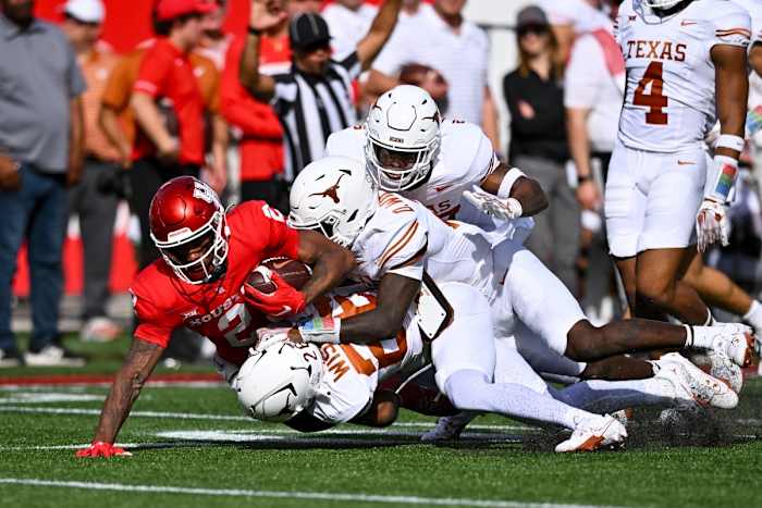 The Texas defense swarms a Houston ball carrier